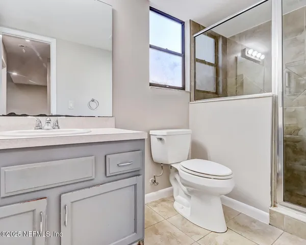 a bathroom with a sink toilet and mirror