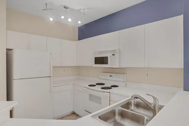 a kitchen with a sink a stove and refrigerator