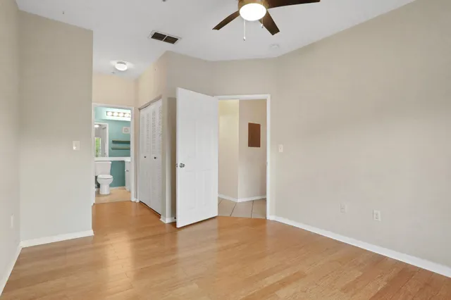 a bathroom with a sink toilet vanity and shower