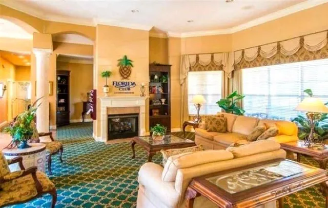 a living room with furniture potted plant kitchen view and a window