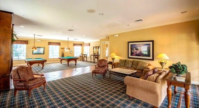 a room with pool table and a window