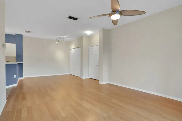 a view of empty room with ceiling fan