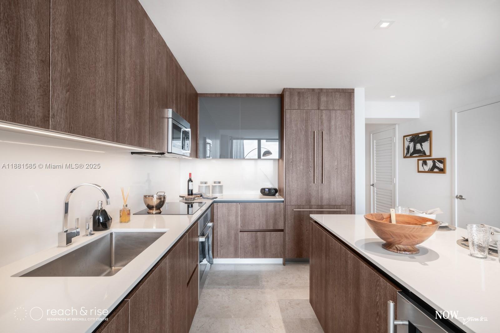 88 Southwest 7th Street, Unit 2406 Miami, FL 33130 - Photo 4 of 15 a kitchen with a sink and cabinets