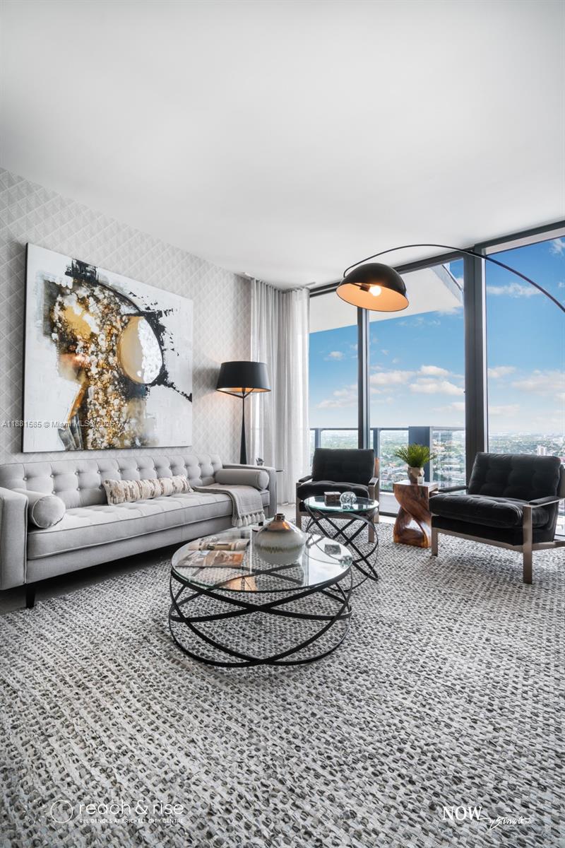 88 Southwest 7th Street, Unit 2406 Miami, FL 33130 - Photo 6 of 15 a living room with furniture and a table