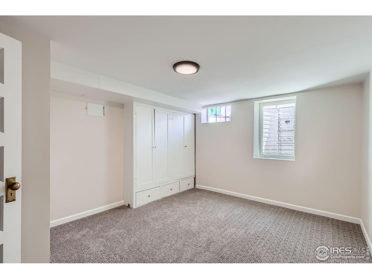 865 Holly Street Denver, CO 80220 - Photo 13 of 18 a view of an empty room with a window