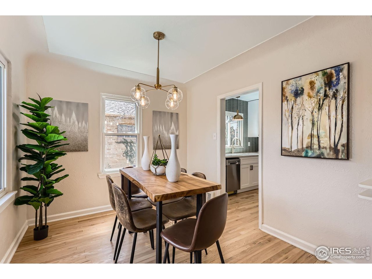 865 Holly Street Denver, CO 80220 - Photo 4 of 18 a view of a dining room with furniture window and wooden floor
