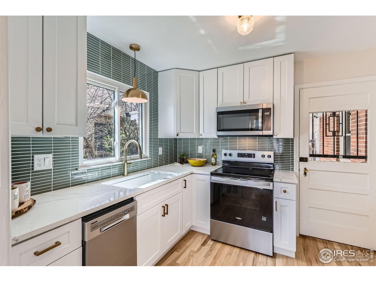 865 Holly Street Denver, CO 80220 - Photo 5 of 18 a kitchen with a sink stove and microwave