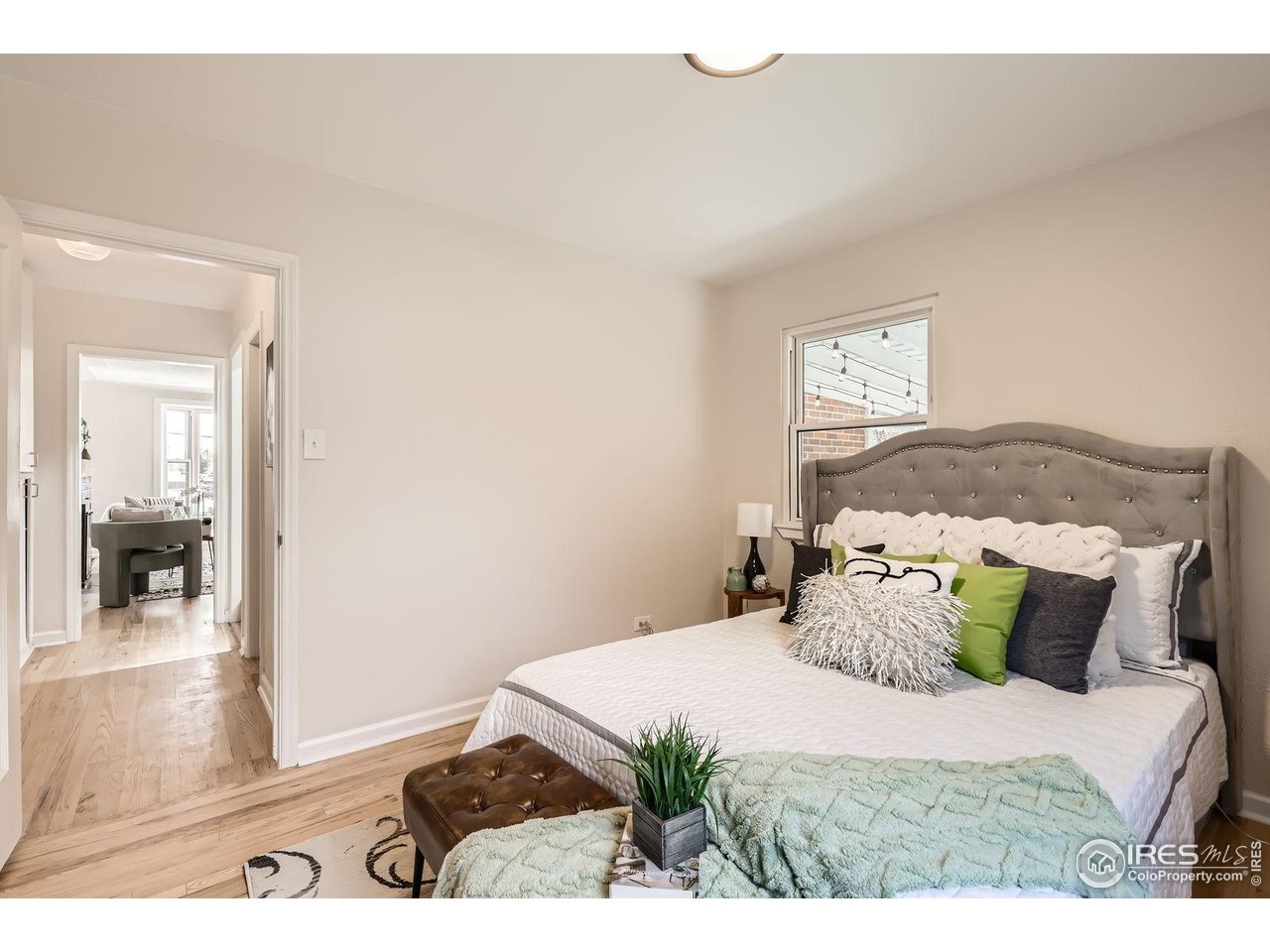 865 Holly Street Denver, CO 80220 - Photo 8 of 18 a bedroom with a bed and wooden floor