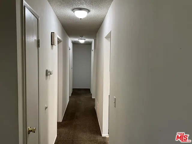 en empty room with a window and a fan