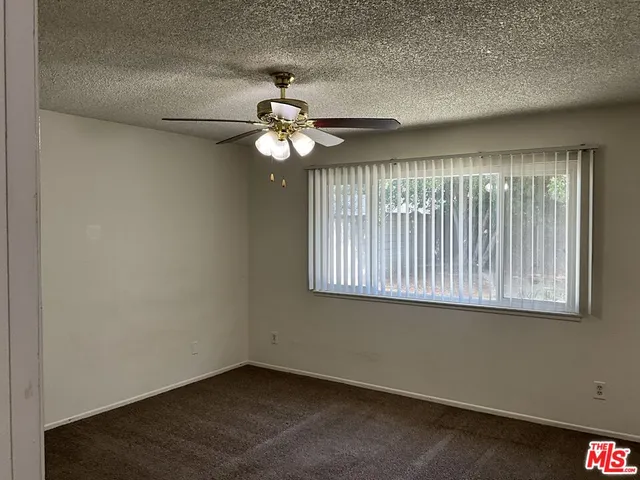 a view of a chandelier fan and refrigerator