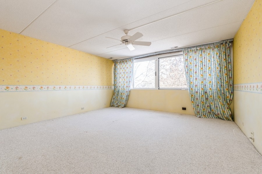 198 Wellington Road Northbrook, IL 60062 - Photo 8 of 14 a view of an empty room with a window