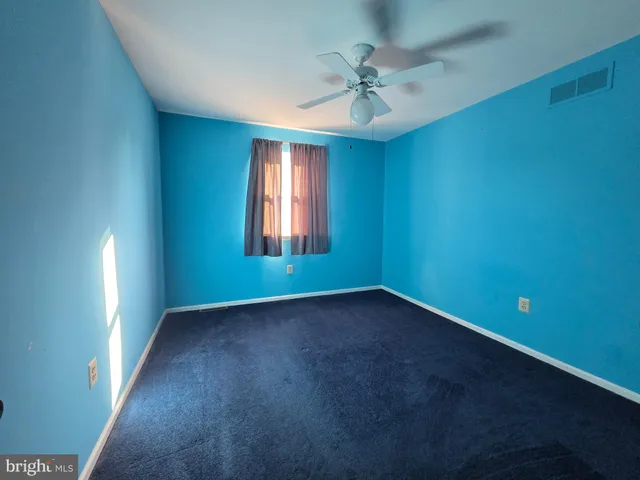 an empty room with a empty space and windows