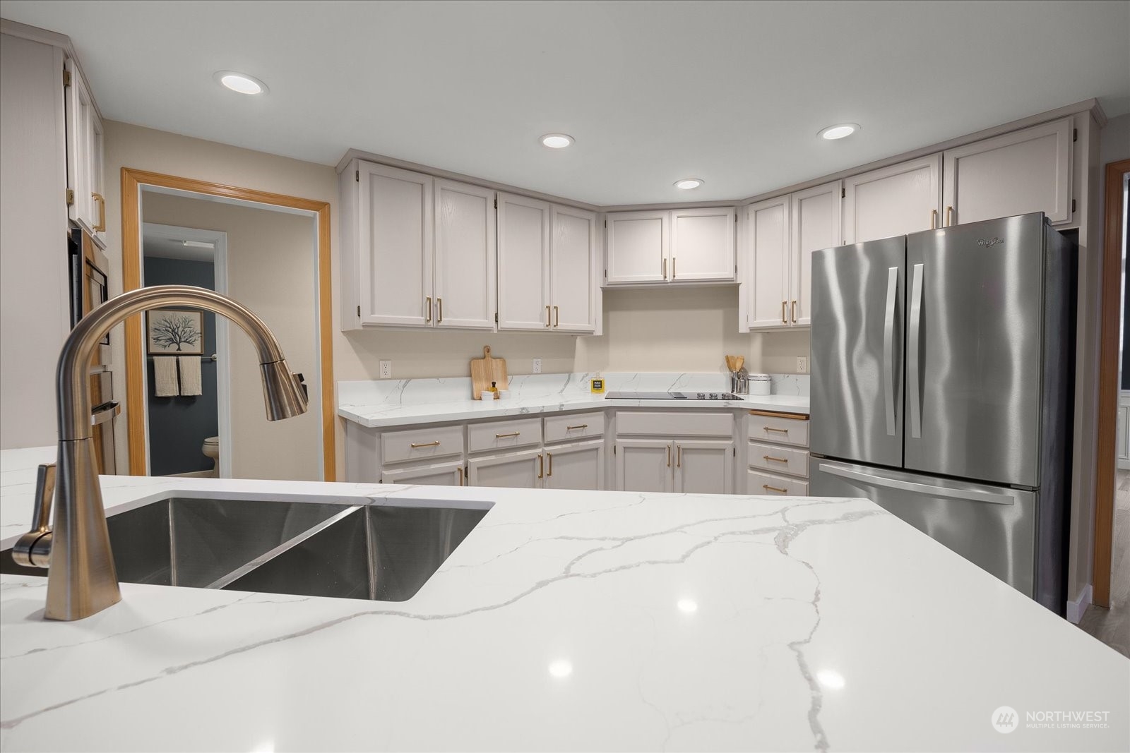 15114 92nd Place Northeast Bothell, WA 98011 - Photo 11 of 34 a kitchen with stainless steel appliances kitchen island a refrigerator sink and cabinets