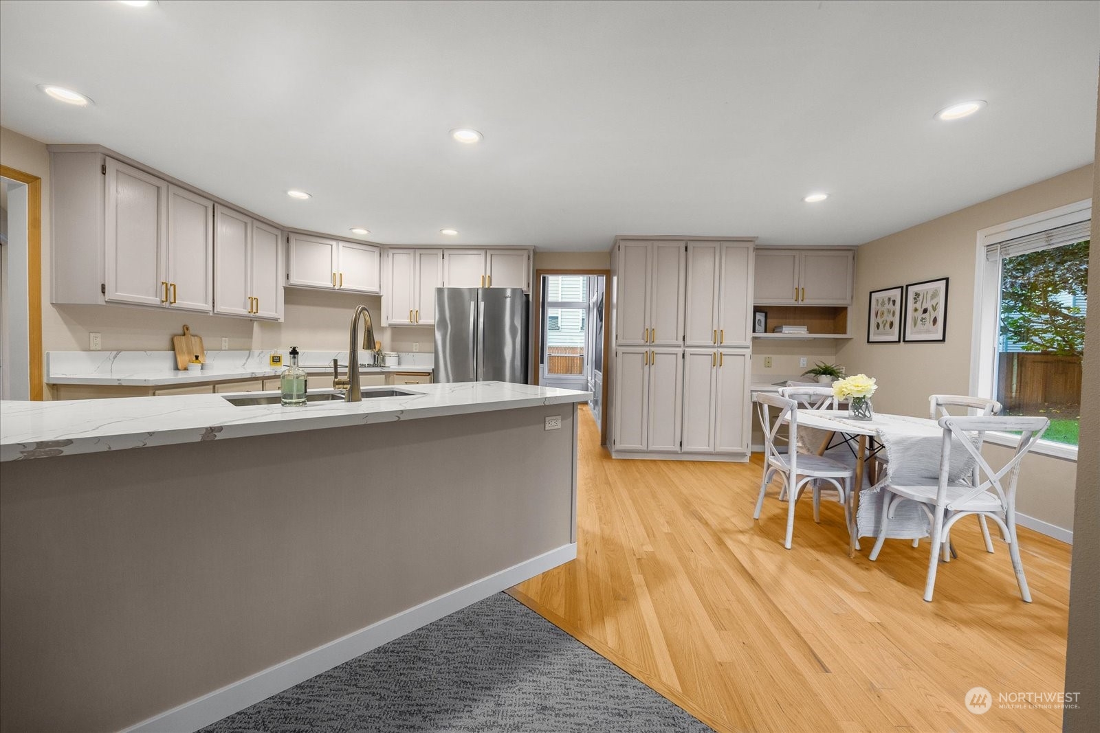 15114 92nd Place Northeast Bothell, WA 98011 - Photo 12 of 34 a kitchen with stainless steel appliances granite countertop a refrigerator a sink a stove a dining table and chairs