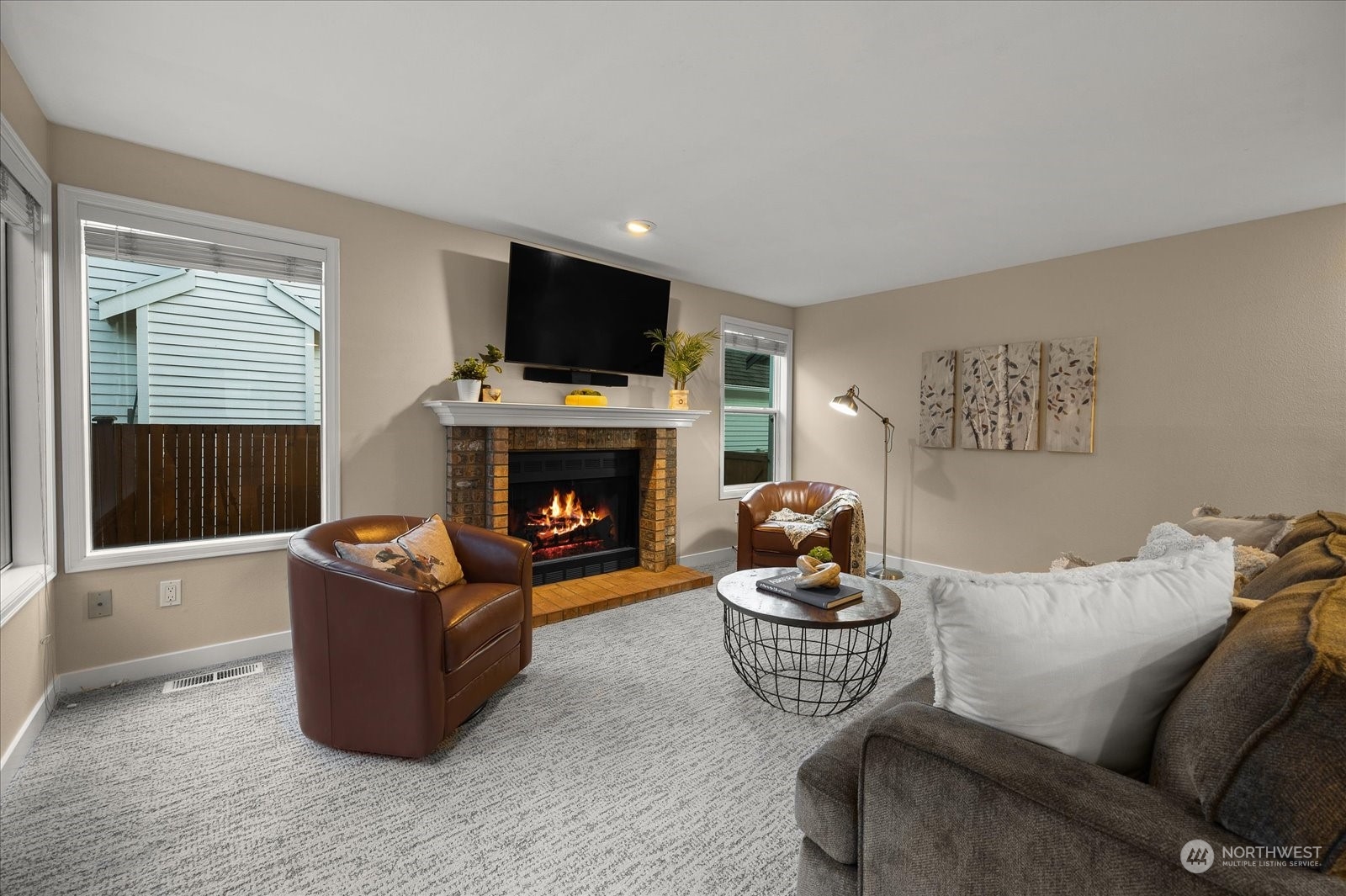 15114 92nd Place Northeast Bothell, WA 98011 - Photo 14 of 34 a living room with furniture a flat screen tv and a fireplace