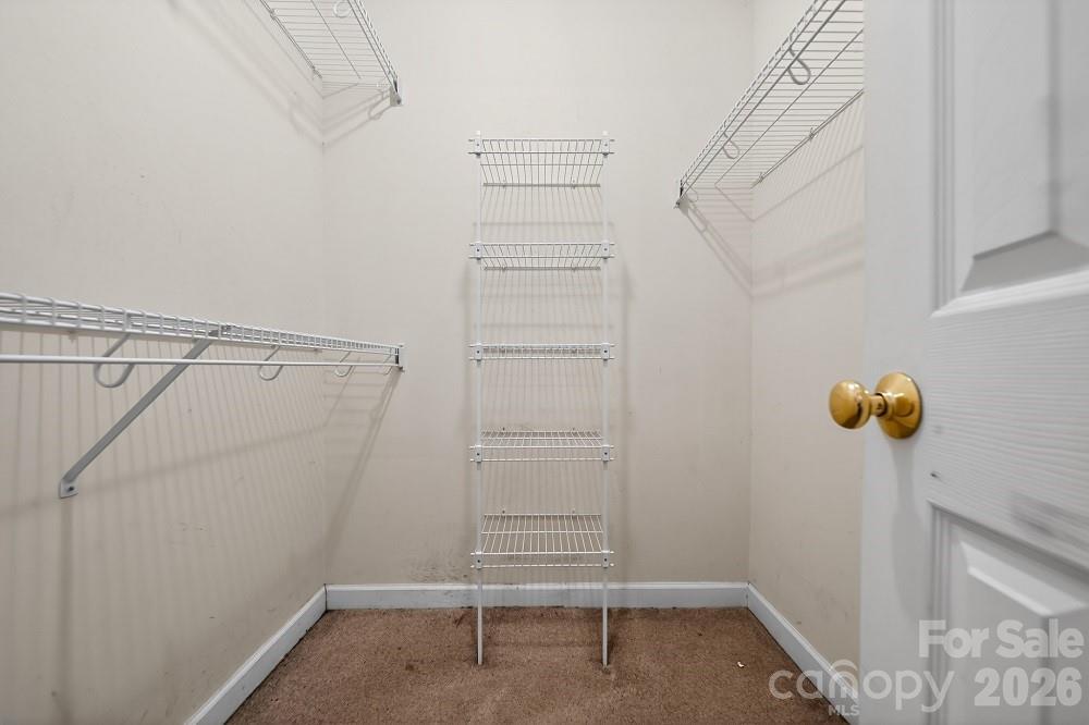 2205 Old Sparta Road Rocky Mount, NC 27804 - Photo 18 of 25 a view of walk in closet with empty racks