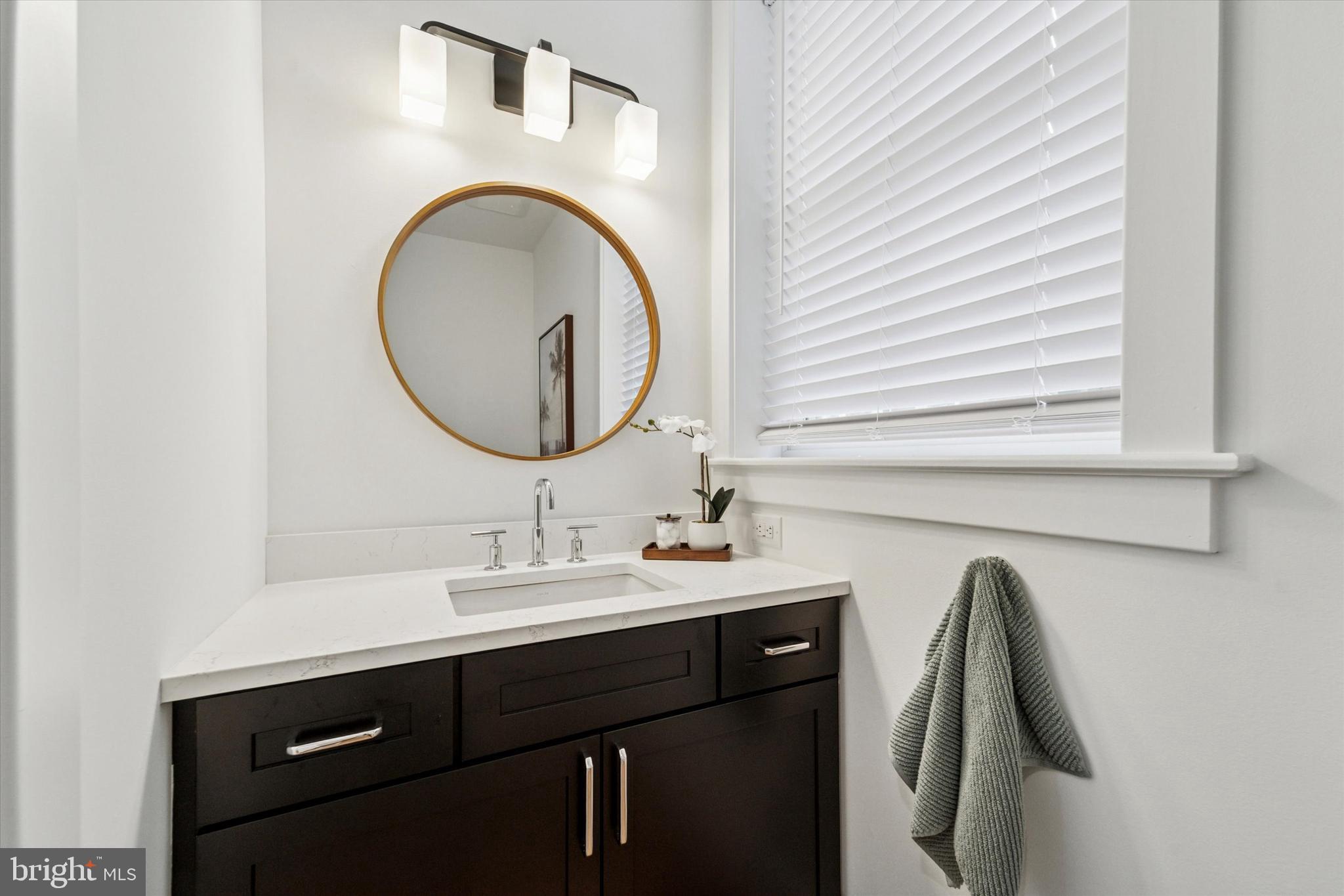 25 North Ridge Avenue, Unit A Ambler, PA 19002 - Photo 13 of 26 a bathroom with a sink and a mirror