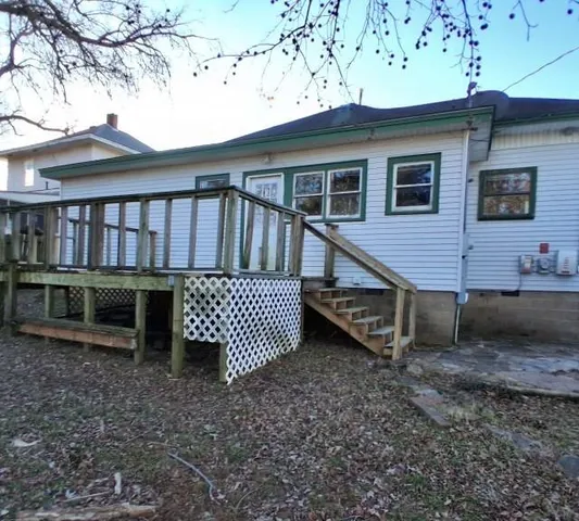 a front view of a house with a wooden deck