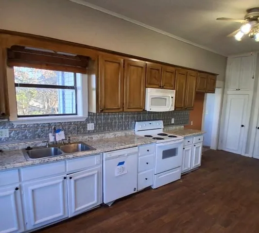 a kitchen with sink and cabinets