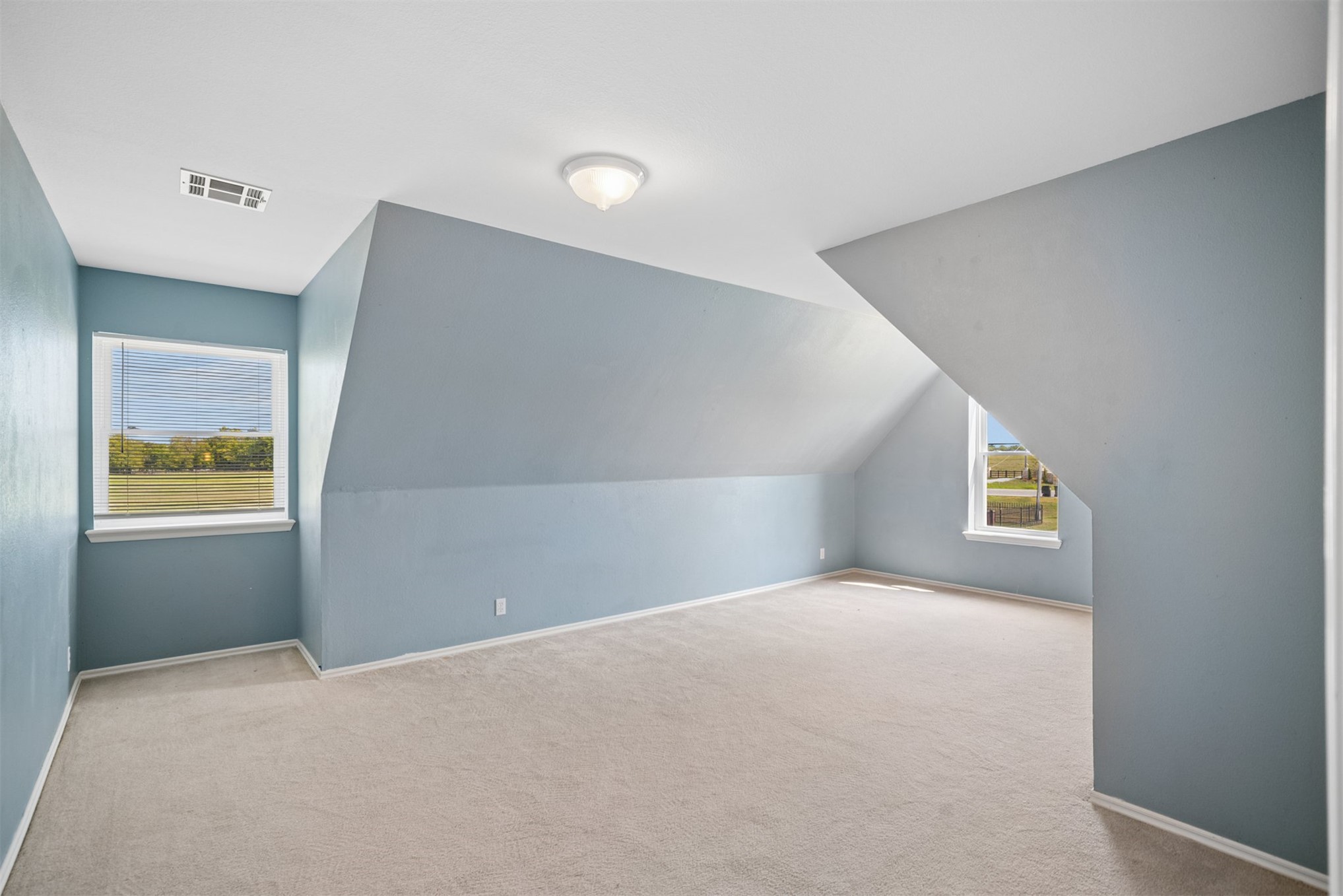 175 Alt 75 Mounds, OK 74047 - Photo 31 of 41 Carpeted flooring, sloped ceiling architectural elements, two windows, and overhead lighting