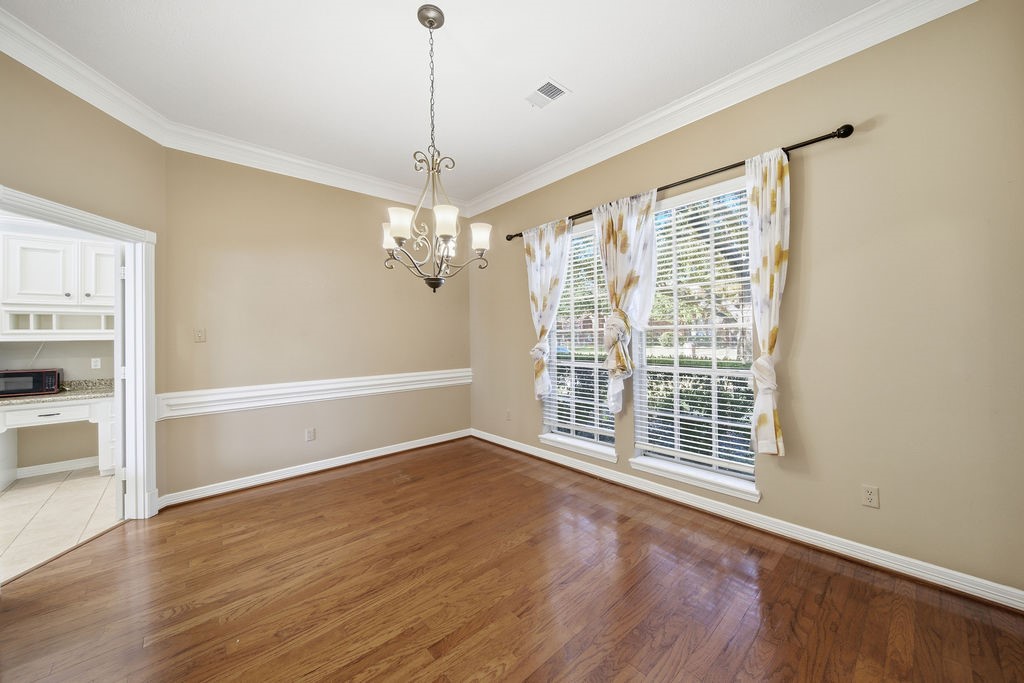 5811 Desert Oak Way Spring, TX 77379 - Photo 16 of 43 a view of an empty room with wooden floor and a window