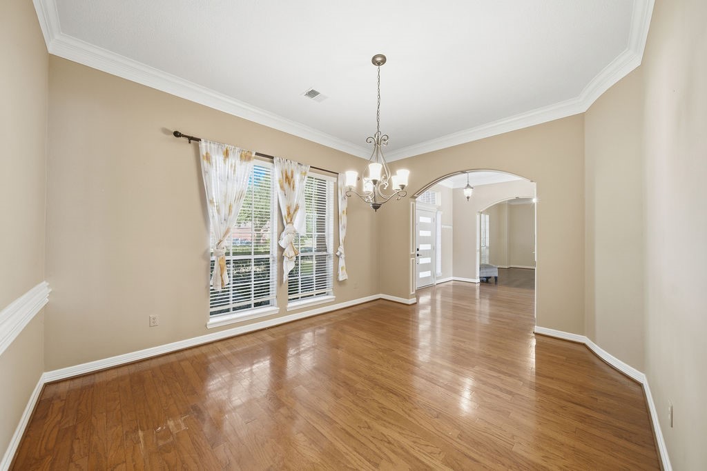 5811 Desert Oak Way Spring, TX 77379 - Photo 17 of 43 a view of an empty room with window and wooden floor