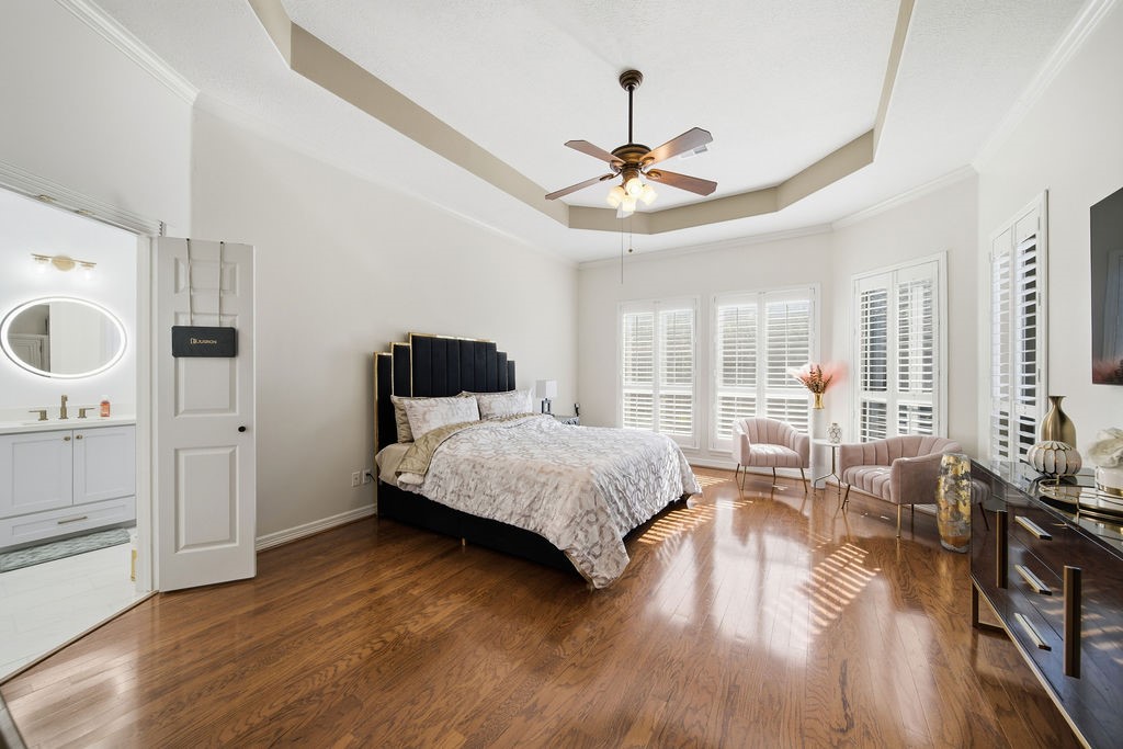 5811 Desert Oak Way Spring, TX 77379 - Photo 24 of 43 a spacious bedroom with a bed and wooden floor