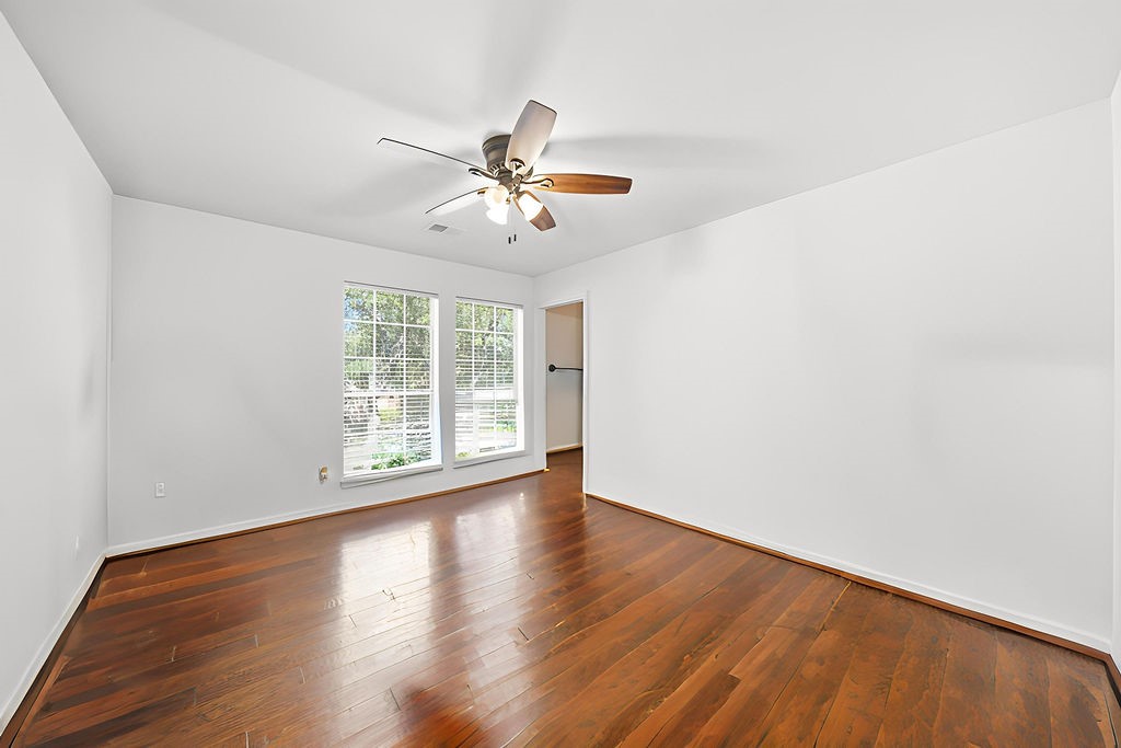 5811 Desert Oak Way Spring, TX 77379 - Photo 31 of 43 a view of empty room with wooden floor and fan