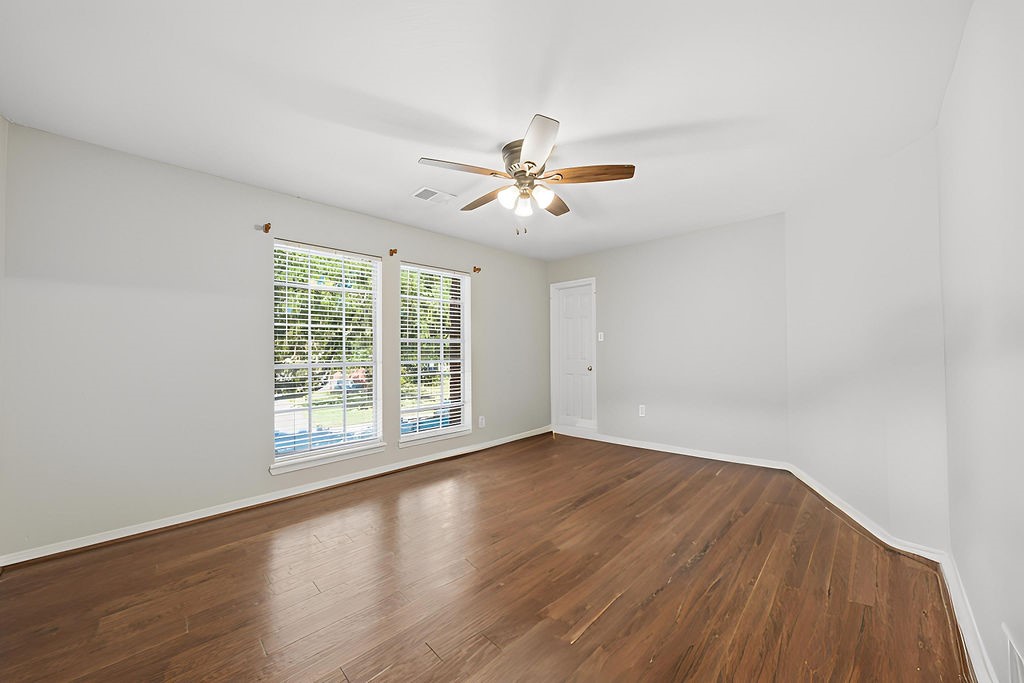 5811 Desert Oak Way Spring, TX 77379 - Photo 36 of 43 an empty room with wooden floor and windows