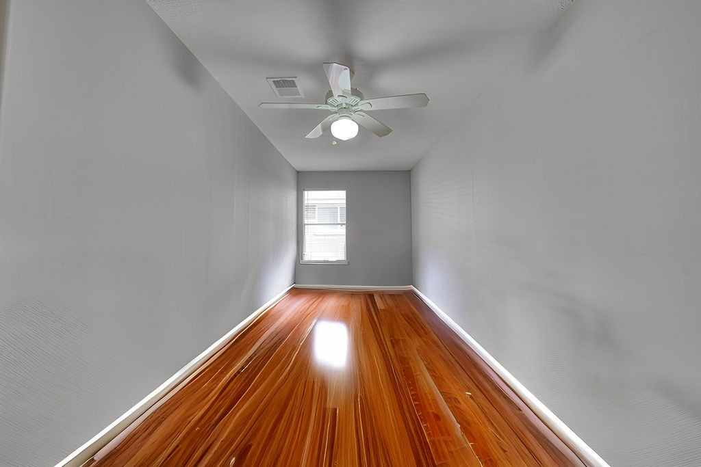 5811 Desert Oak Way Spring, TX 77379 - Photo 37 of 43 a view of an empty room with wooden floor and a window