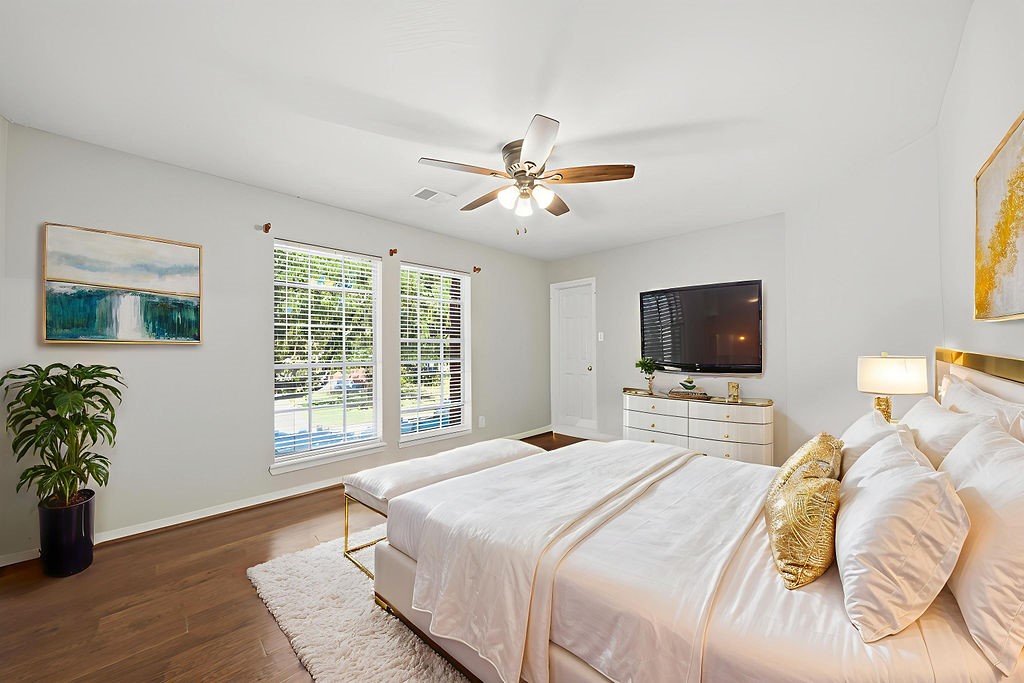 5811 Desert Oak Way Spring, TX 77379 - Photo 8 of 43 a bedroom with a bed and a flat screen tv