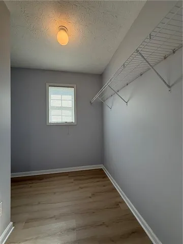 a view of a room with wooden floor and windows in it