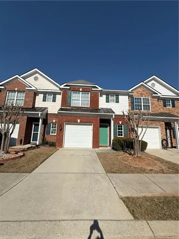 a front view of a house with parking space