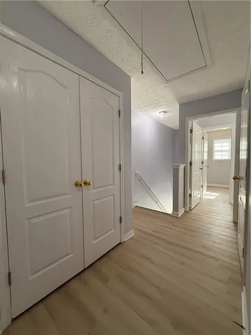 a view of a hallway with wooden floor