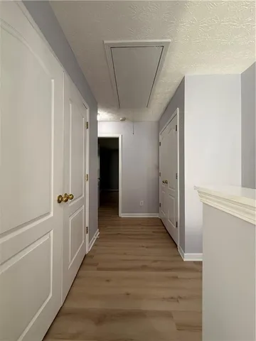 a view of a hallway with wooden floor