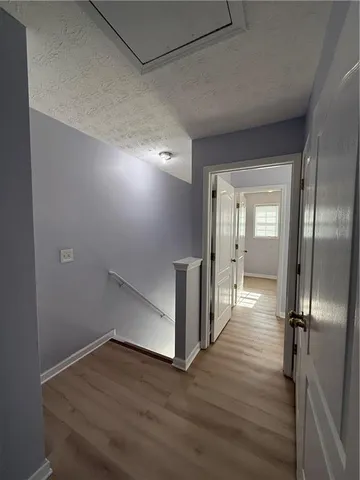 a view of a hallway with wooden floor