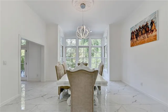a living room with stainless steel appliances kitchen island granite countertop a sink and cabinets