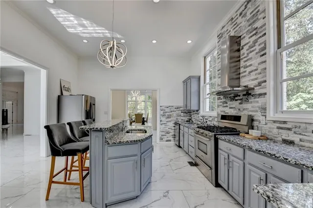 a living room with furniture and floor to ceiling windows