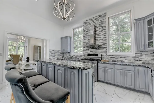 a spacious bathroom with a granite countertop double vanity sink a mirror and a shower