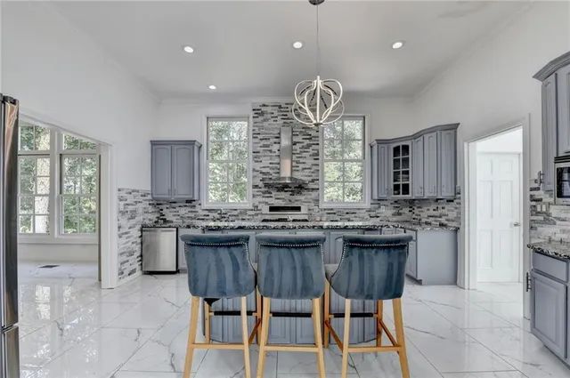a bathroom with a granite countertop sink a large mirror and a shower