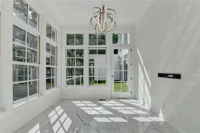 a front view of a house with a yard and trees