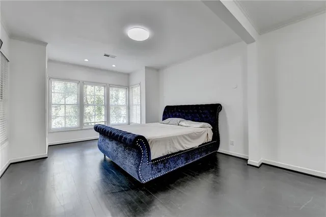 an aerial view of a house with a yard and large trees