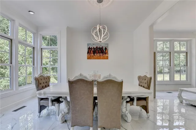 a kitchen with stainless steel appliances kitchen island granite countertop a refrigerator and a stove top oven