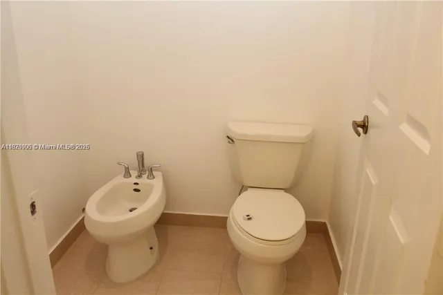 a bathroom with a toilet and a sink