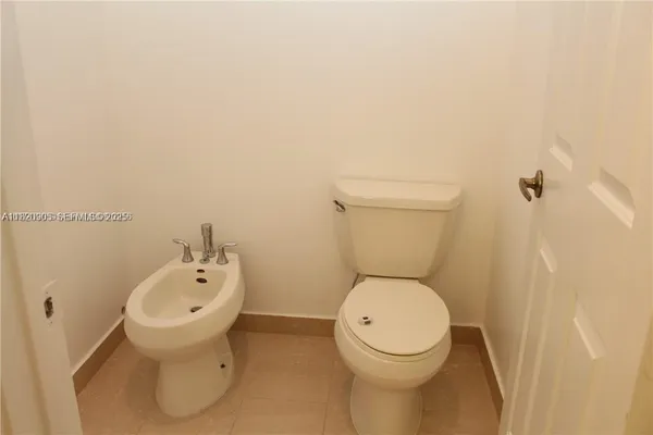 a white toilet sitting next to a white sink