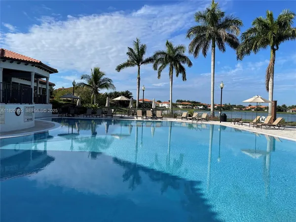 a kitchen with stainless steel appliances kitchen island granite countertop a table and chairs in it