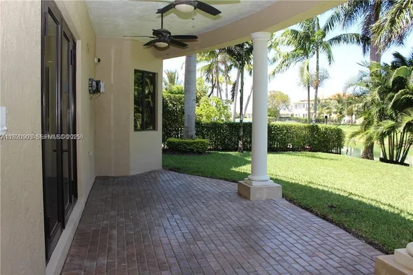 a view of a porch with furniture and garden