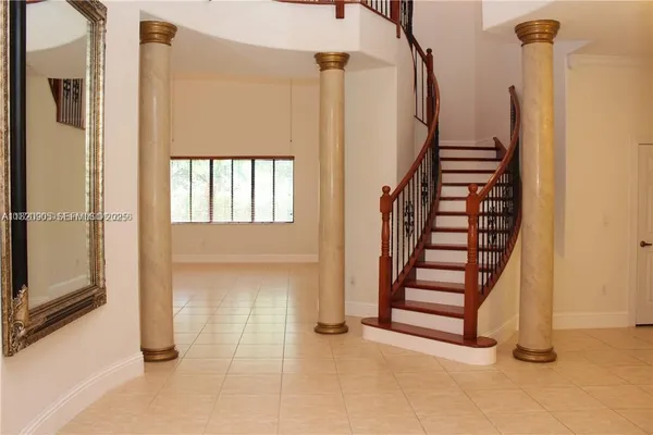 a view of entryway with wooden floor and stairs