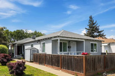 a view of a house with a yard and a garden