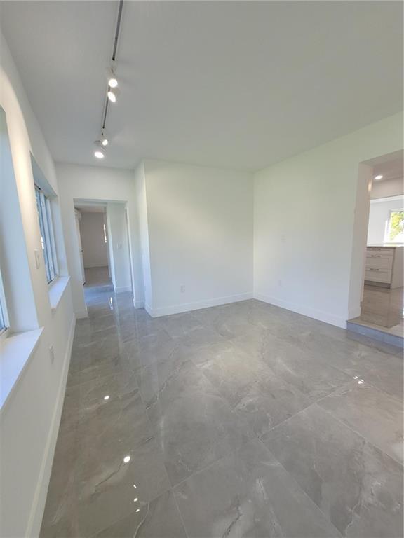 6041 Southwest 17th Street Miami, FL 33155 - Photo 11 of 26 wooden floor in an empty room with a window